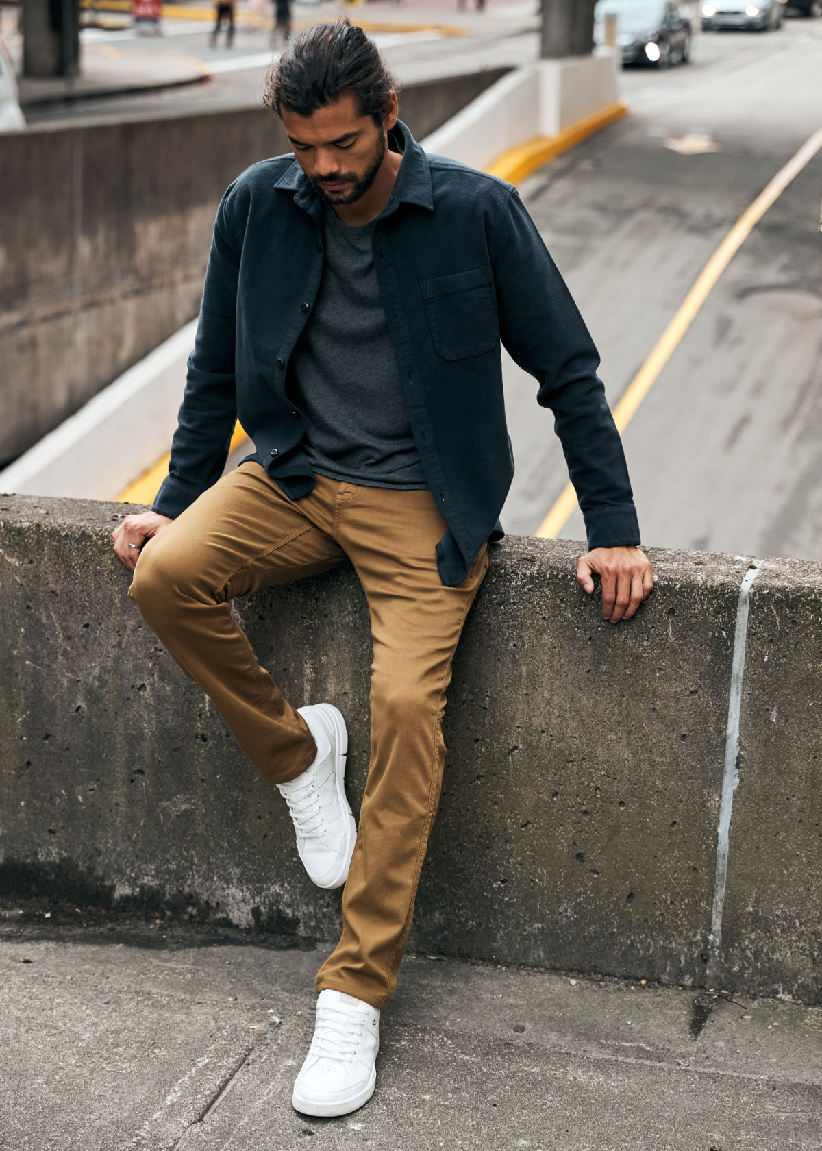 man wearing mustard dress sweatpant outside in the city