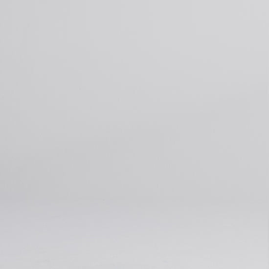 Woman wearing a dark wash relaxed fit stretch jeans walking onto screen, posing, and crouching down to face the camera.