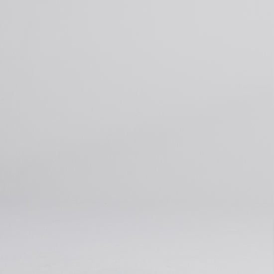 Woman wearing a dark wash relaxed fit stretch jeans walking onto screen, posing, and crouching to face the camera.