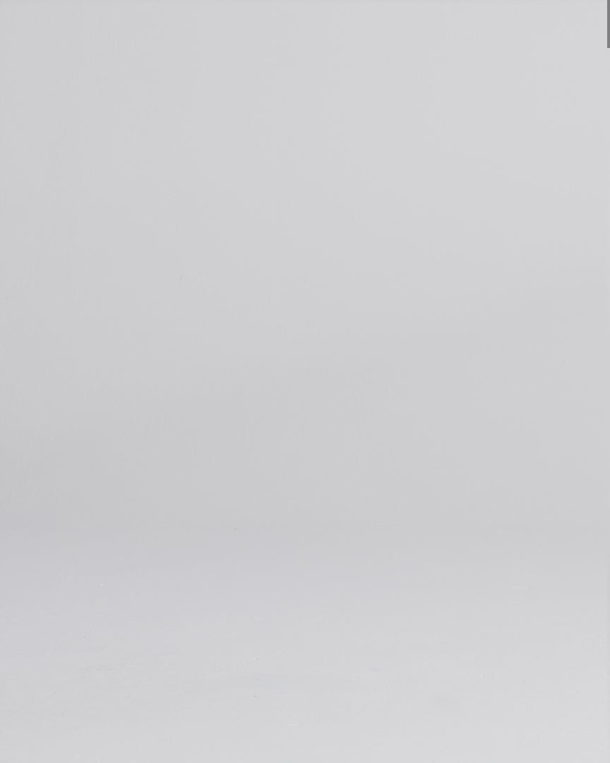 Woman wearing a dark wash relaxed fit stretch jeans walking onto screen, posing, and crouching to face the camera.