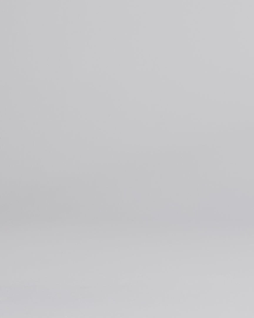 Man wearing dark wash slim fit stretch jeans walking into the frame, posing and adjusting the cuff.